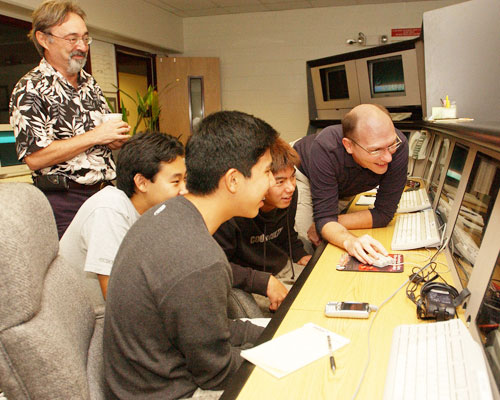 Gemini's Head of Science, Dr. Jean-René Roy looks on as Ken Oyadomari, Keane Nakatsu, Nick Higa and Gemini astronomer Dr. Scott Fisher (foreground to background) collect comet data at the Gemini North control room in Hilo.