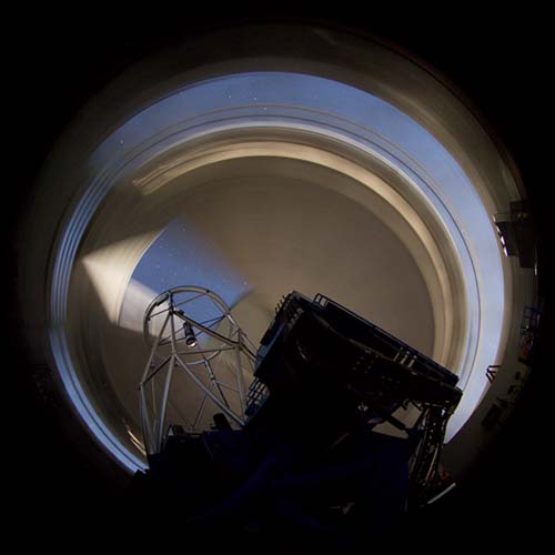 Picture of the Gemini dome blurried in the background demonstrating its movements agains the stationary telescope.