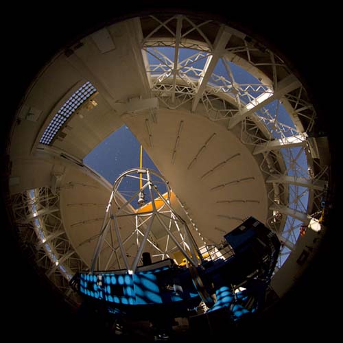 Picture of the laser guide star propagating from the inside of the Gemini North telescope.