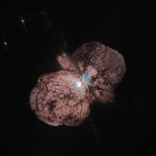 View of the supermassive star Eta Carinae surrounded by a billowing par of gas and dust clouds.