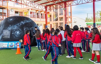 Students at the Giant Magellan Telescope portable planetarium show during Viaje al Universo 2023