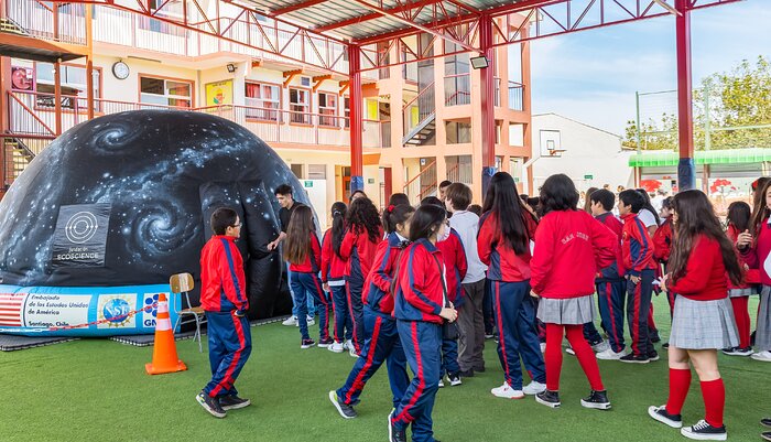 Students at the Giant Magellan Telescope portable planetarium show during Viaje al Universo 2023