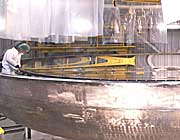 Picture of the optical engineer Maxime Boccas inspecting the Gemini South primary mirror after exiting the coating chamber.