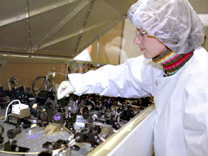 Picture of Gemini’s Lead Laser Engineer Celine d’Orgeville inspecting the inside of the Gemini laser system which is about the size of a small piano.